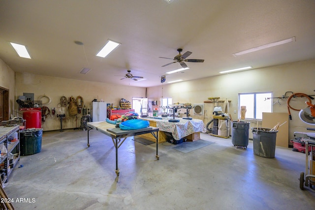 garage with a workshop area and ceiling fan