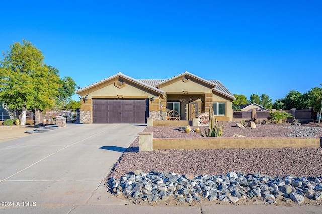 5701 N 105th Ln, Glendale, AZ 85307 - ranch-style home with stucco siding, an attached garage, driveway, stone siding, and a tile roof
