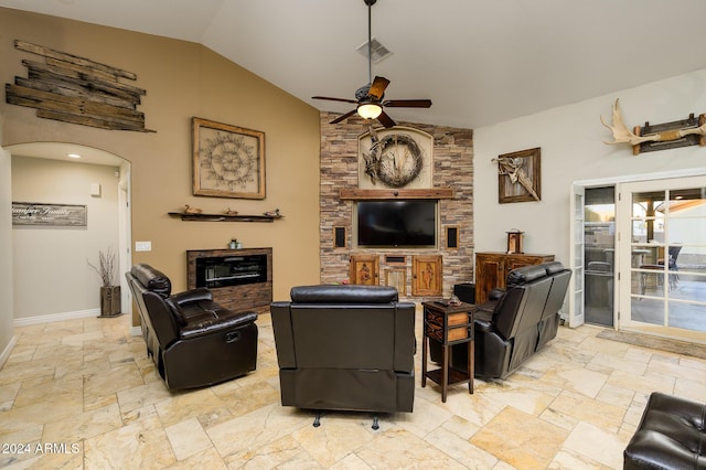 5701 N 105th Ln, Glendale, AZ 85307 - living room with a ceiling fan, lofted ceiling, arched walkways, baseboards, and stone tile flooring