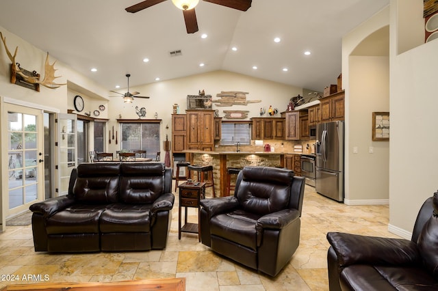 living room featuring sink and high vaulted ceiling