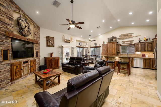 living room with ceiling fan, sink, and high vaulted ceiling