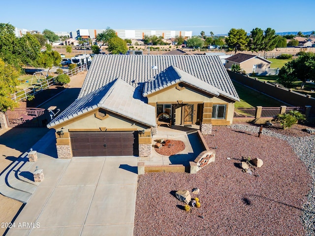 5701 N 105th Ln, Glendale, AZ 85307 - view of front of property with a tiled roof, a garage, concrete driveway, stucco siding, and stone siding