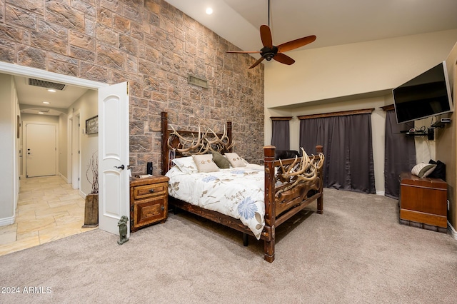 carpeted bedroom featuring high vaulted ceiling and ceiling fan