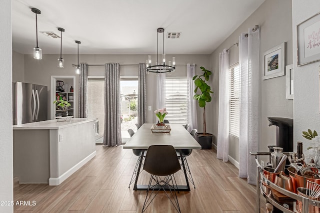 872 E Saratoga St, Gilbert, AZ 85296 - dining room featuring light wood-style flooring, baseboards, and a chandelier