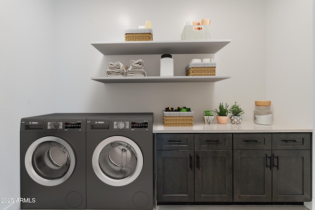 washroom with cabinet space and washing machine and clothes dryer