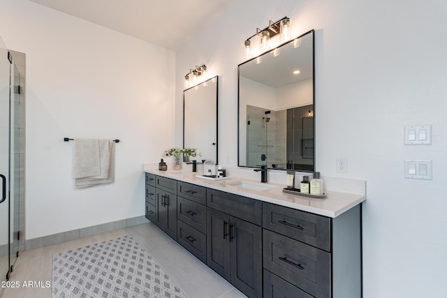 full bathroom featuring tile patterned flooring, a sink, baseboards, double vanity, and a stall shower