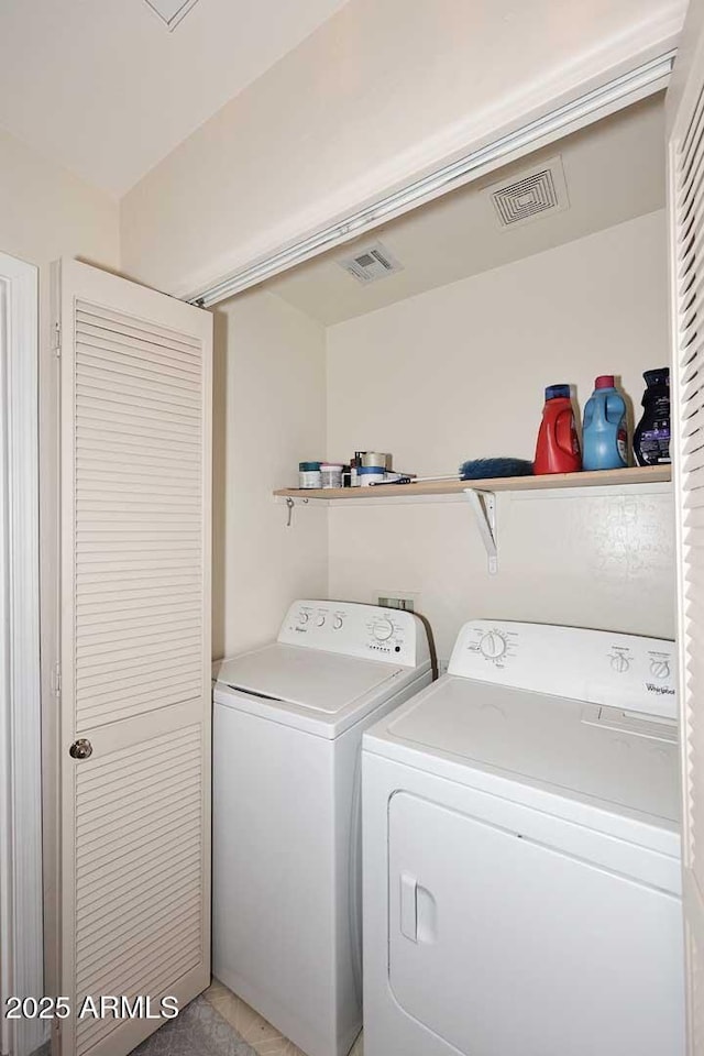 laundry area featuring washing machine and dryer and visible vents