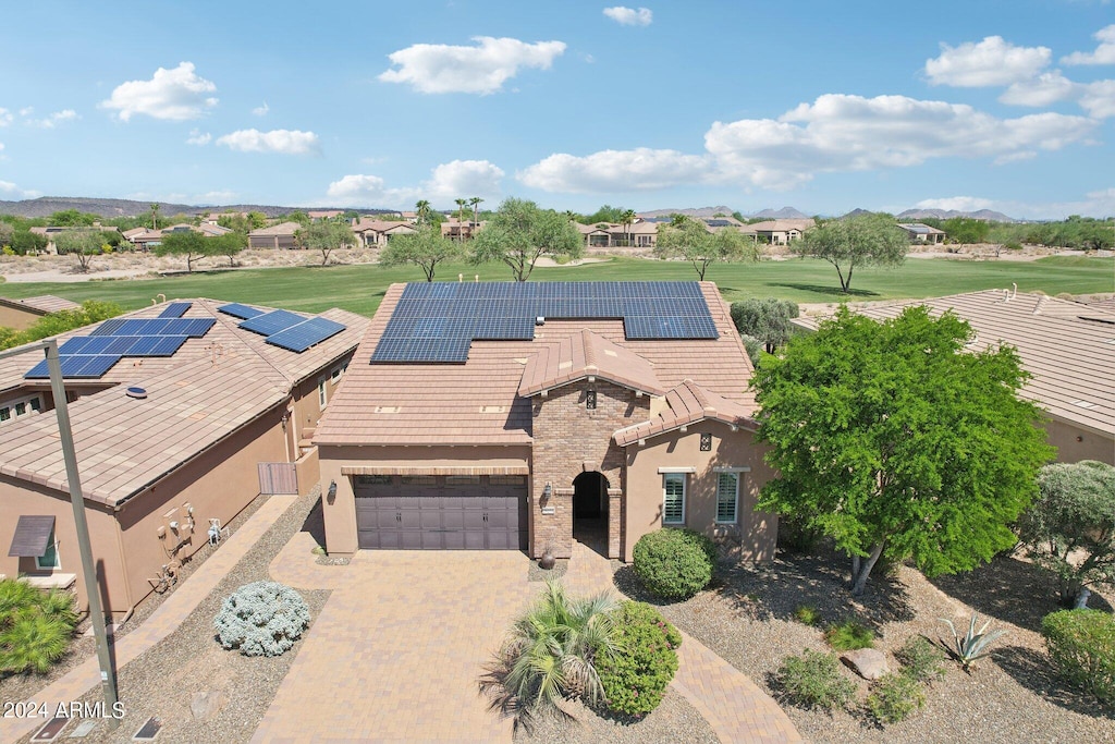 view of front of home with solar panels and a garage