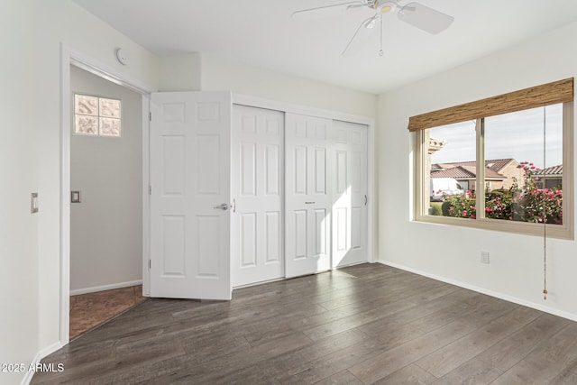 unfurnished bedroom with ceiling fan, a closet, and dark hardwood / wood-style flooring