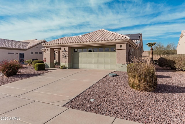 view of front of property with a garage and solar panels