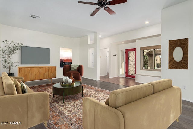 living room with ceiling fan and dark hardwood / wood-style flooring