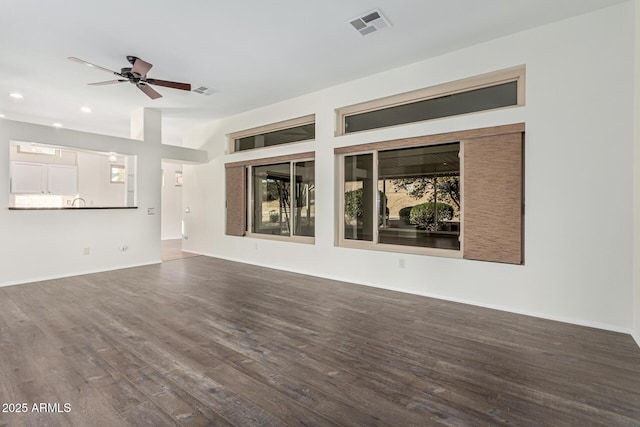 unfurnished living room with ceiling fan and hardwood / wood-style floors