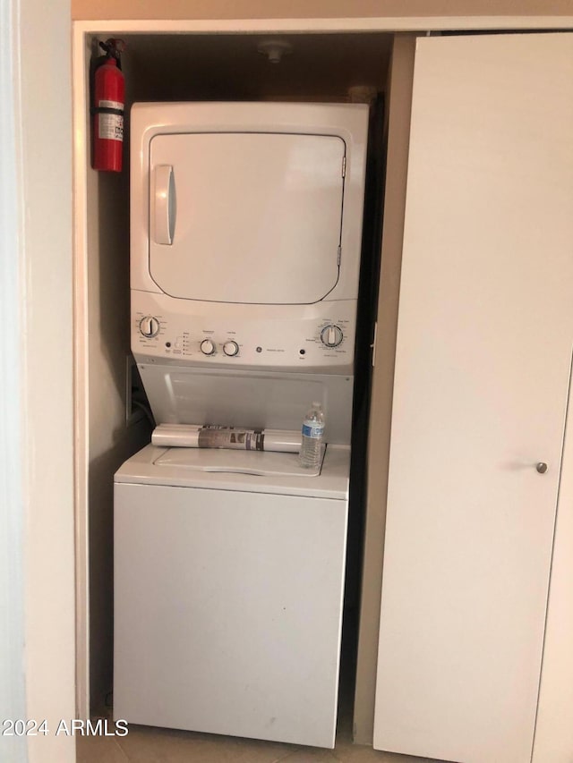 laundry room featuring stacked washer / drying machine