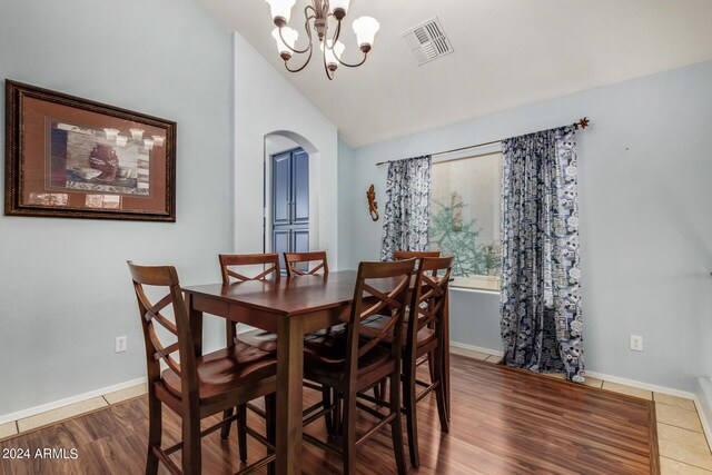 2977 E County Down Dr, Chandler, AZ 85249 - dining room featuring visible vents, baseboards, arched walkways, a notable chandelier, and vaulted ceiling