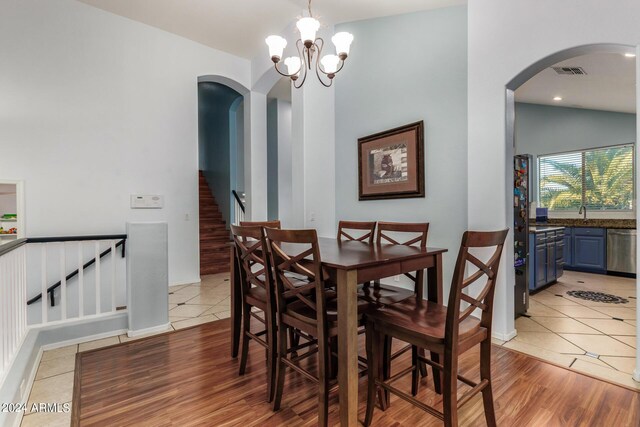 2977 E County Down Dr, Chandler, AZ 85249 - dining area featuring an inviting chandelier, light tile patterned floors, arched walkways, visible vents, and stairway