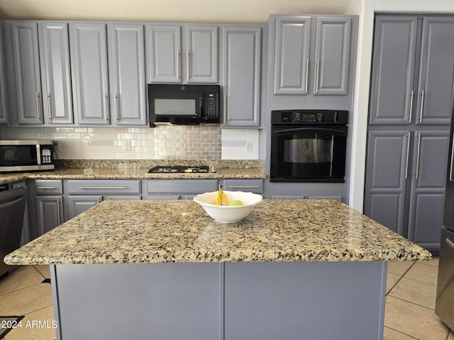 2977 E County Down Dr, Chandler, AZ 85249 - kitchen with light tile patterned floors, decorative backsplash, black appliances, and gray cabinets