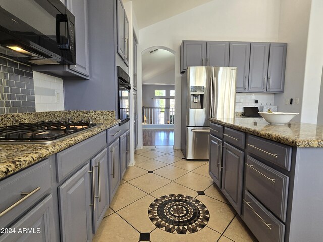 2977 E County Down Dr, Chandler, AZ 85249 - kitchen with backsplash, black appliances, arched walkways, and gray cabinetry