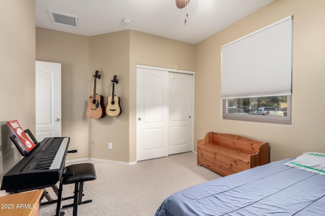 carpeted bedroom featuring a closet, ceiling fan, and baseboards