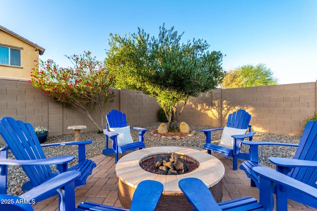view of patio with an outdoor fire pit and a fenced backyard