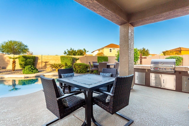view of patio featuring grilling area, area for grilling, outdoor dining area, and a fenced backyard