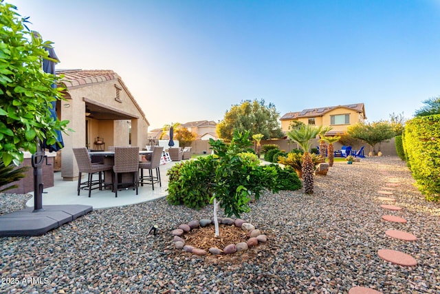 fenced backyard featuring a patio and outdoor dining area