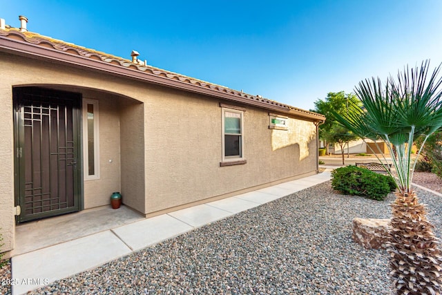 view of side of home featuring stucco siding