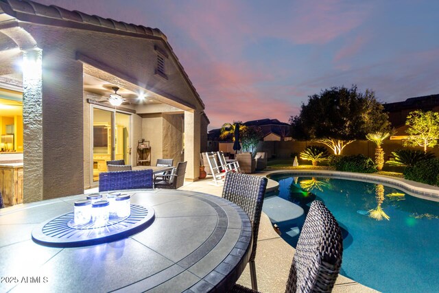 view of swimming pool with outdoor dining area, a fenced backyard, and a patio