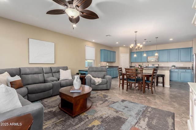 living area featuring a chandelier and a ceiling fan