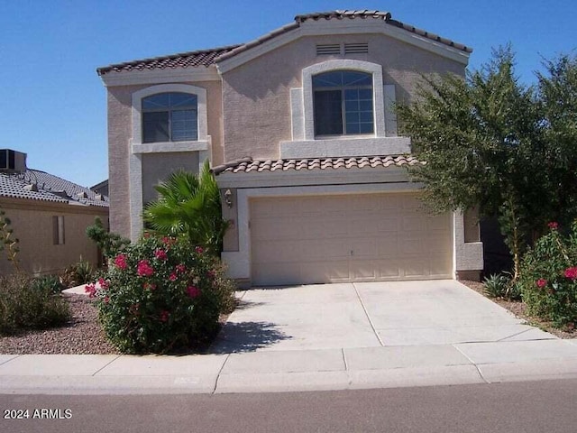 mediterranean / spanish-style home with a garage