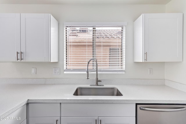 kitchen featuring white cabinets, a wealth of natural light, and dishwasher