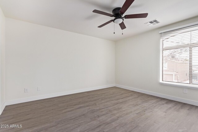 empty room featuring hardwood / wood-style floors and ceiling fan