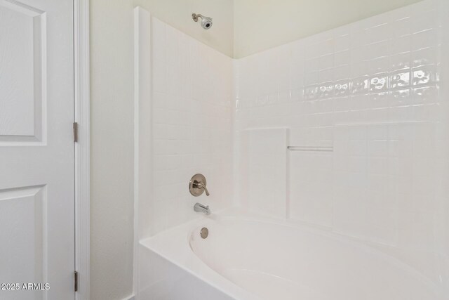 bathroom with bathing tub / shower combination