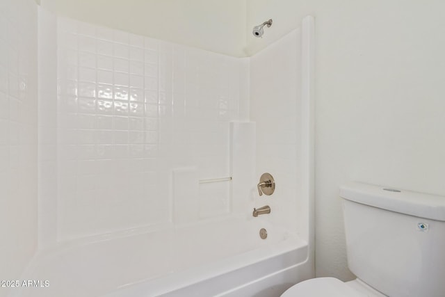 bathroom with shower / washtub combination and toilet