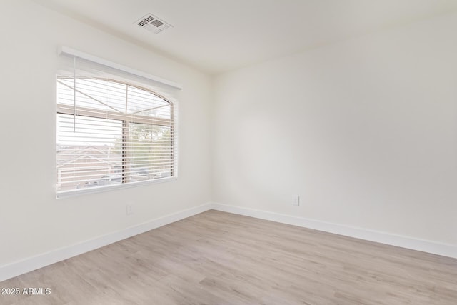 unfurnished room with light hardwood / wood-style flooring