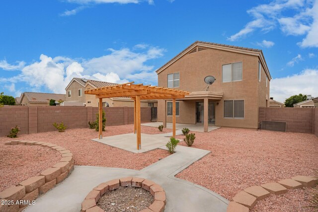 back of property with a pergola and a patio area