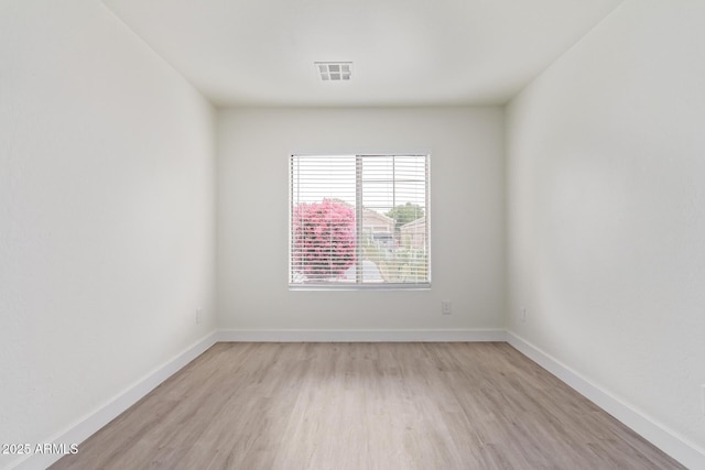 unfurnished room with light wood-type flooring