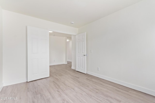 unfurnished bedroom with light wood-type flooring