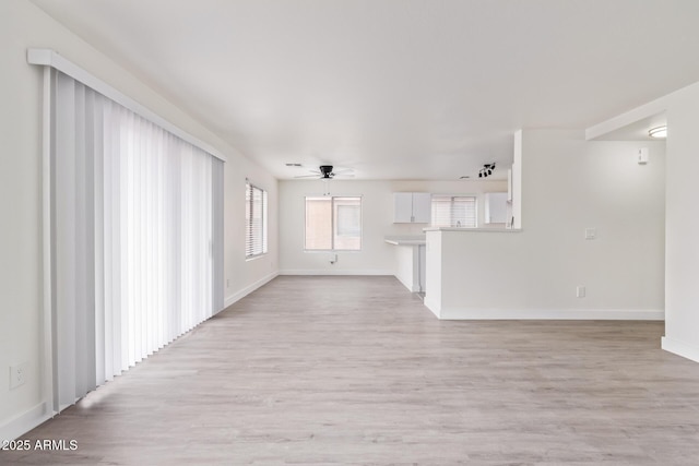 unfurnished living room with ceiling fan and light hardwood / wood-style flooring