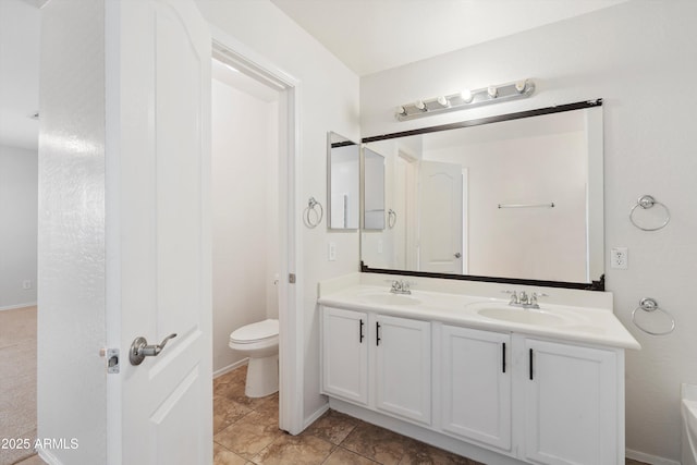 bathroom featuring tile patterned floors, vanity, and toilet