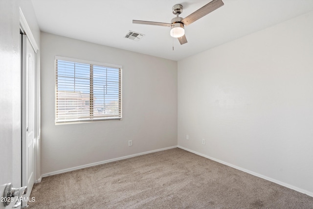 unfurnished room featuring light colored carpet and ceiling fan