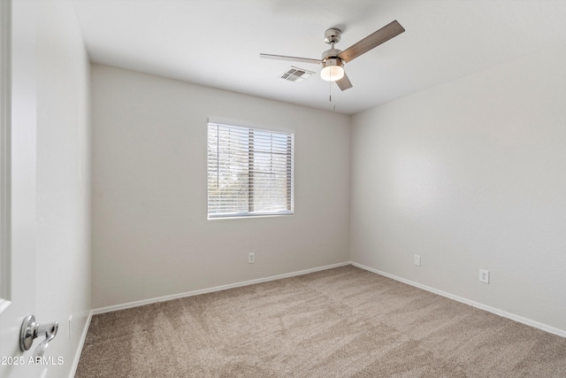 carpeted spare room with ceiling fan