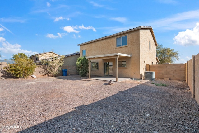 back of house with central AC unit and a patio