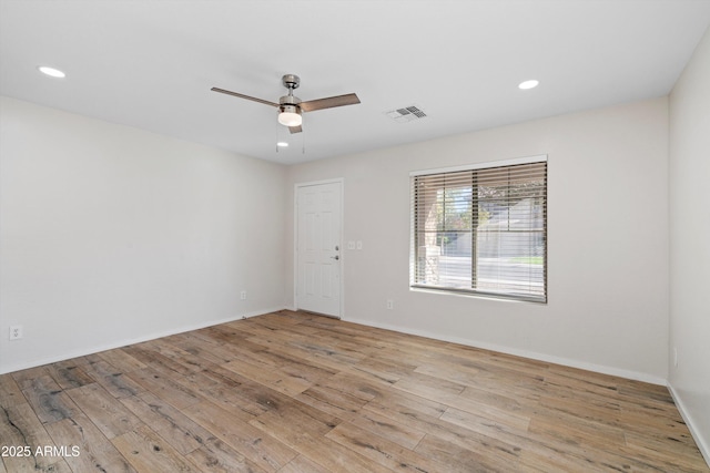 spare room featuring light wood-type flooring and ceiling fan