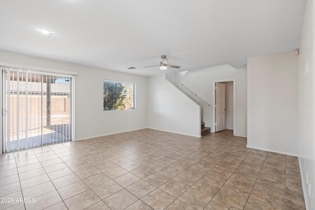 unfurnished living room featuring ceiling fan and light tile patterned floors