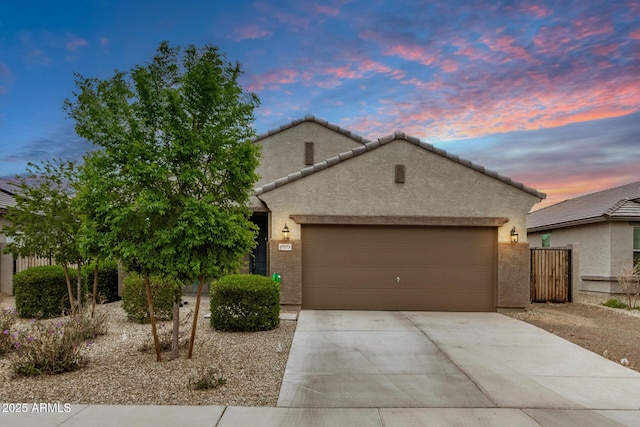 17573 W Via De Luna Dr, Surprise, AZ 85387 - view of front of property featuring stucco siding, an attached garage, driveway, and a tile roof