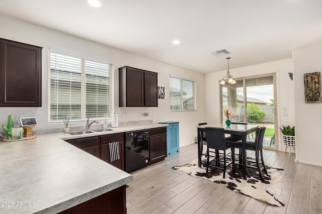 17573 W Via De Luna Dr, Surprise, AZ 85387 - kitchen featuring dishwasher, a sink, dark brown cabinets, a chandelier, and light countertops