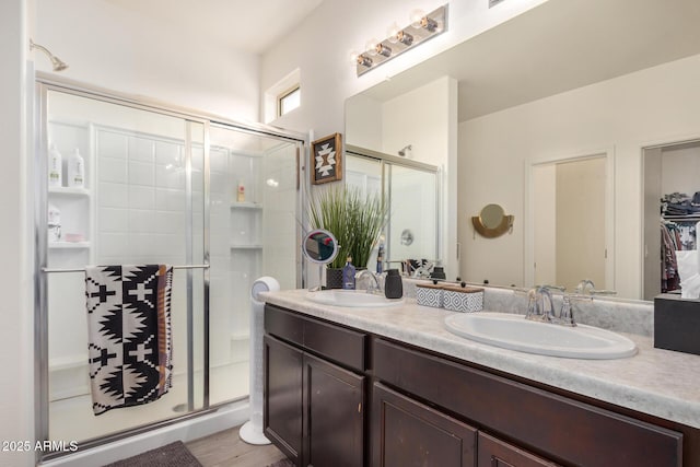 17573 W Via De Luna Dr, Surprise, AZ 85387 - full bath with a stall shower, double vanity, and wood finished floors