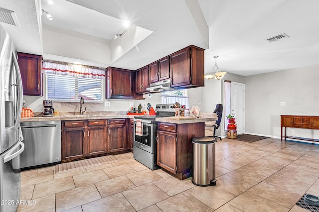 6055 E Hannibal St, Mesa, AZ 85205 - kitchen featuring stainless steel appliances, light countertops, plenty of natural light, and a tray ceiling