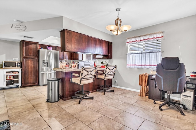6055 E Hannibal St, Mesa, AZ 85205 - kitchen featuring appliances with stainless steel finishes, a peninsula, light countertops, a chandelier, and light tile patterned flooring