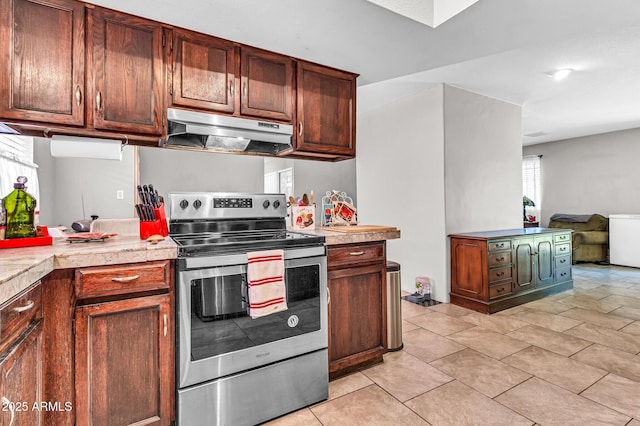 6055 E Hannibal St, Mesa, AZ 85205 - kitchen with electric range, under cabinet range hood, light countertops, and light tile patterned floors